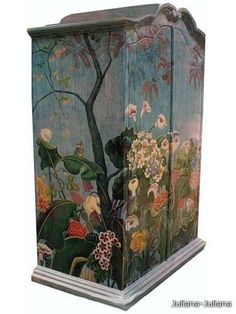 an artisticly painted wooden cabinet with flowers and butterflies on the front, sitting against a white background