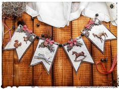 some white and red decorations on a wooden table with string attached to the top of it