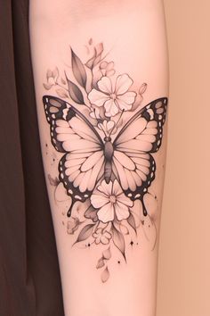 a woman's leg with a butterfly and flowers tattoo on the side of her thigh