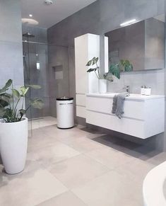 a bathroom with a sink, toilet and bathtub in the middle of two pictures