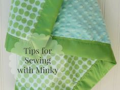 a green and white polka doted blanket hanging on a door with text overlay that reads tips for sewing with minky