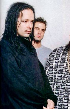 two men standing next to each other with dreadlocks on their heads and one wearing a black shirt