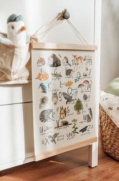 an animal alphabet print hanging on a wall