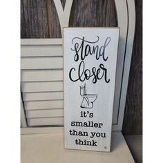 a sign that says stand closer it's smaller than you think on a chair