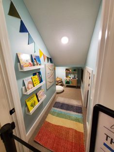 a hallway with bookshelves and rugs on the floor