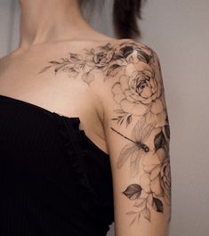 a woman with a flower tattoo on her shoulder