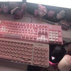 a pink keyboard and mouse on a desk