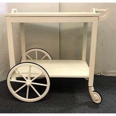 a white cart with wheels is sitting on the floor