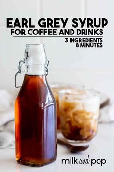 a bottle of coffee syrup next to a glass jar filled with liquid and ice cubes