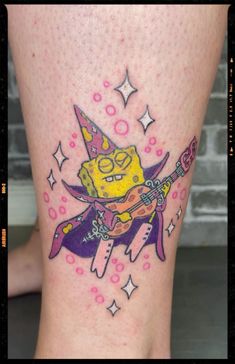 a cartoon character tattoo on the leg