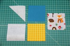 four pieces of fabric laid out on top of a cutting mat