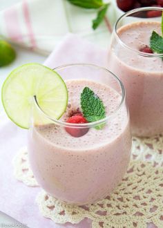 two glasses filled with smoothie on top of a doily