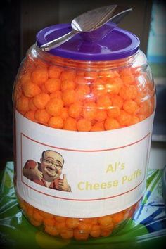 a jar filled with orange candies sitting on top of a table