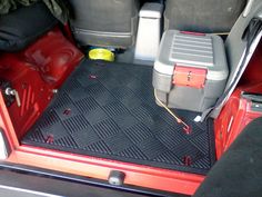 the interior of a red car with two coolers on it's back seats