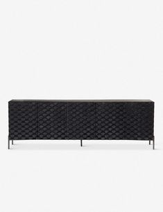 the sideboard is made out of black woven material and has metal legs, which are also