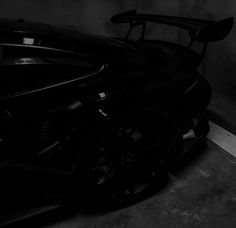 a black sports car parked in a garage