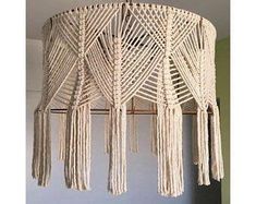 a white chandelier with tassels hanging from it's sides in a room