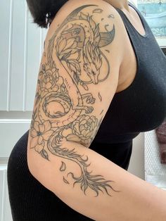 a woman with a dragon tattoo on her arm