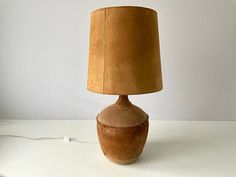 a lamp that is sitting on top of a white table next to a light bulb