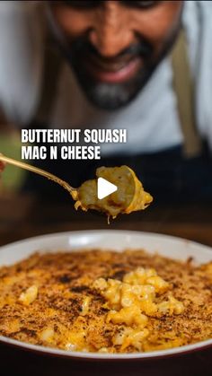 a man holding a spoon full of macaroni and cheese with the caption butternut squash mac n cheese