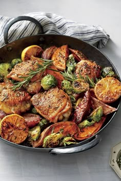 a pan filled with meat and vegetables on top of a table