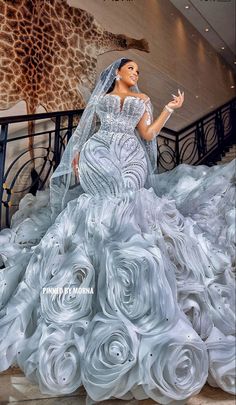 a woman in a wedding dress standing on stairs