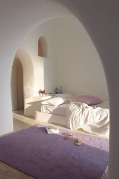 a bedroom with white walls and purple carpet