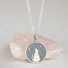 "Such a fun new necklace for cat lovers! This sterling silver pendant has some brass accents to make it truly unique. This pendant measures 16mm round. You have a choice for this necklace to pair the pendant with a 14k gold filled cable chain or a sterling silver cable chain with the length options of 16\", 18\" and 20\".  Get this limited edition necklace while you can!" Silver Cat Design Round Necklace, Elegant Cat Design Pendant Jewelry, Adjustable Silver Necklace With Cat Design, Silver Cat Design Necklace, Star And Moon Necklace, Cat Necklace Silver, Lover Jewelry, Silver Cat Design Pendant Charm Necklace, Star Moon