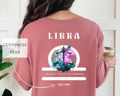 a woman wearing a t - shirt that says libra on the front and back