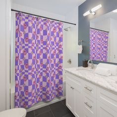 a bathroom with purple and white checkered shower curtain