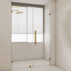 a white bathroom with gold accents and a large window