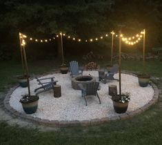 an outdoor fire pit surrounded by chairs and lights