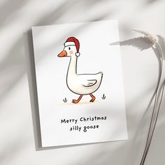 a white card with a duck wearing a santa hat on it's head and the words merry christmas silly goose