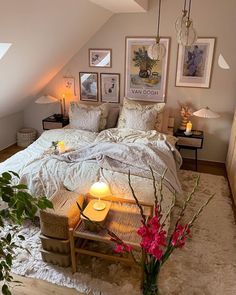 a bedroom with white bedding and lots of pictures on the wall next to it