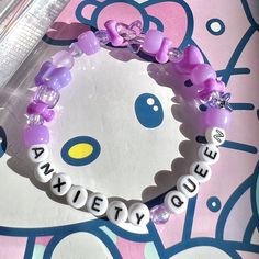 give yourself a break, *anxiety queen* 💜✨ details ❥ approximately 6.5 inches & super stretchy 🐛 ❥ can be adjusted to your sizing :) 🌈 ❥ want this same design but want it to say something else? i can do that ⚡️ Kuromi Inspired Bracelet, Disney Kandi Bracelets, Pastel Bracelet Ideas, Diy Bracelet Designs Beads, Pony Beads Ideas, Candy Bracelet Ideas, Rave Kandi Bracelets Ideas, Ideas For Bracelets With Beads, Bracelet Patterns Ideas