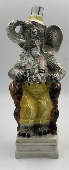 an elephant figurine wearing a top hat