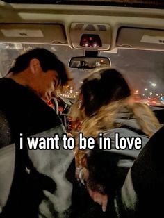 two people in a car with the words i want to be in love