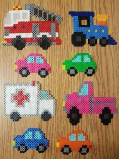 cross stitch cars are arranged on a wooden surface