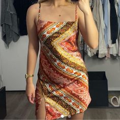 a woman taking a selfie in front of a mirror wearing a dress and holding a cell phone