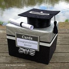 a graduation cap and diploma sitting on top of a box with the words congratulationss kevini