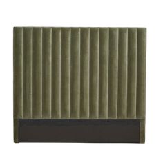 an upholstered headboard made out of green velvet with black trimmings