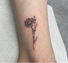 a small sunflower tattoo on the ankle