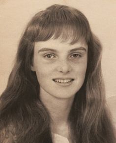 an old photo of a woman with long hair