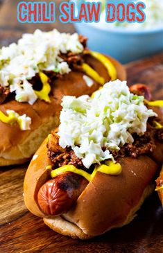 two hot dogs with toppings are on a plate