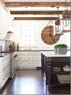 a kitchen with white cabinets and wooden floors