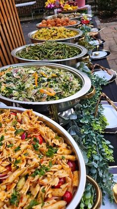 many plates of food are lined up on a table