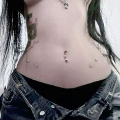 a woman with piercings on her stomach