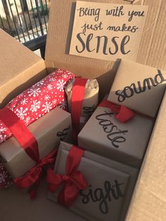 several boxes with wrapped presents sitting on top of each other in front of a sign that says, being with you just makes sense