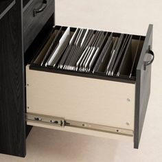 an open drawer with silverware in it