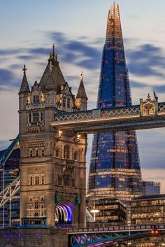 the tower bridge is lit up at night